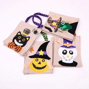 Set of 4 Halloween burlap candy bags with cartoon pumpkin, skull, and witch designs