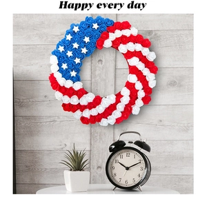 Patriotic red white and blue artificial rose wreath hanging on a rustic wood wall
