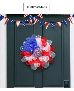 Detail of red white and blue USA Independence Day wreath hanging on a dark wood door