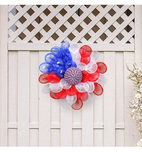 Detail view of USA Independence Day wreath with red white blue mesh and star decor