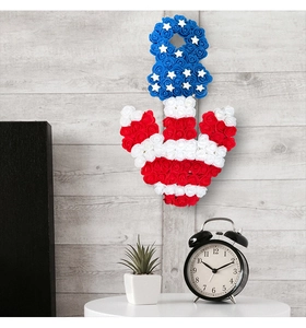 Detail of anchor-shaped patriotic wall hanging with red white and blue foam roses