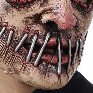 Macro view of scary Halloween mask with blood stains and metal mouth stitching details