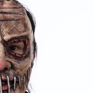 Macro shot of Halloween mask with realistic skin folds and metallic stitched seam details