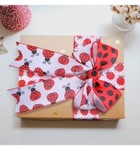 Ladybug pattern ribbon tied in a bow on a brown gift box for creative decoration