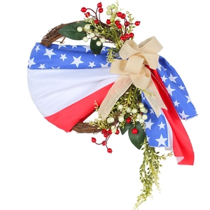 Patriotic USA Independence Day wreath with burlap bow and flag fabric on grapevine base
