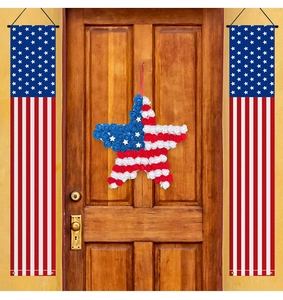 Close-up of US Independence Day 5-point star wreath and patriotic banners on a wooden door