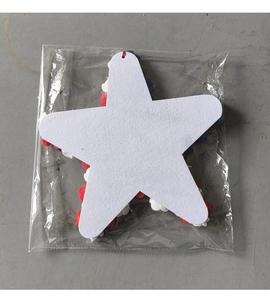 Close-up of patriotic star wreath in red, white, and blue felt petals in retail packaging
