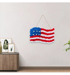 Detail of American flag wall decor made with faux roses and stars hanging on a grey wall