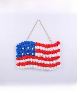 Front view detail of American flag floral door hanger made of red white blue foam roses