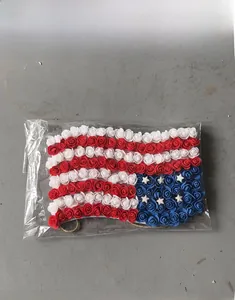 Detail of USA flag themed decorative door hanging made with red white and blue foam roses