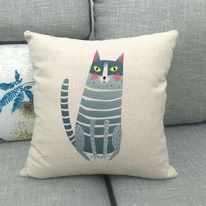 Detail of square linen pillowcase featuring a cartoon cat design on a gray sofa
