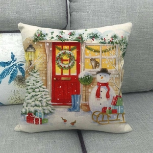 Detailed view of linen Christmas cushion cover with festive snowman and red door prints