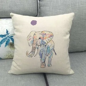Close-up of linen pillowcase with watercolor elephant print on a grey fabric sofa