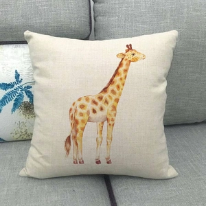 Detailed view of linen pillow cover with orange giraffe watercolor illustration on grey sofa