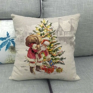 Detailed close-up of a Santa Claus linen cushion cover on a modern grey sofa