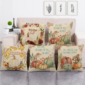 Detailed view of fall cushion covers featuring linen texture and autumn nature motifs