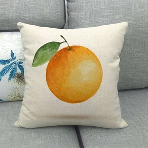 Close-up of linen pillow cover featuring watercolor orange print on a grey fabric sofa