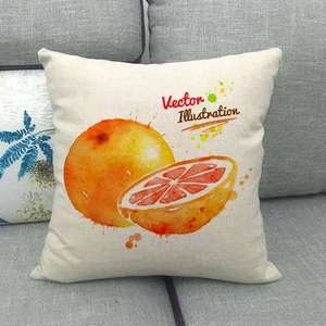 Close-up of linen cushion cover featuring vibrant orange fruit watercolor illustration on sofa