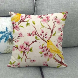 Linen sofa cushion cover featuring yellow bird and pink floral branch design