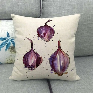 Artistic watercolor red onion print on a rustic linen pillowcase on a grey sofa