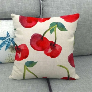 Detailed texture of linen pillowcase with watercolor cherry print on a gray sofa