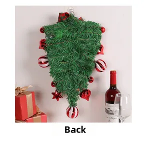 Detail view showing the back side of the Christmas wreath with green pine and red decor