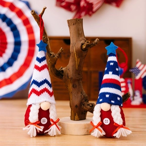 Detail of two knitted patriotic gnomes with red and blue star patterns for Independence Day