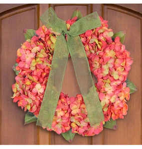 Detail of autumn hydrangea wreath with green plaid bow on wooden door decor