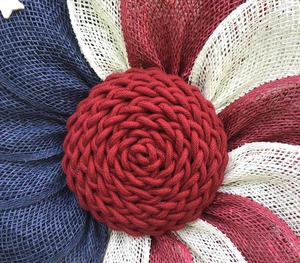 Macro detail of Patriotic Independence Day wreath with red, white and blue burlap mesh
