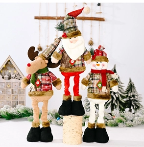 Detail of Christmas telescopic dolls in vintage plaid fabric for holiday table decor