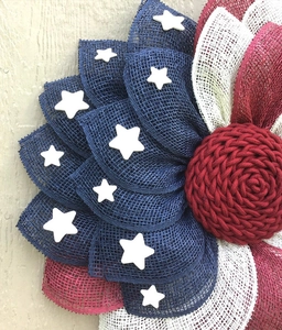 Close-up of patriotic burlap mesh wreath with red white blue stars and stripes details