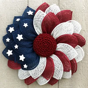 Patriotic Independence Day wreath with red white and blue burlap mesh on wood background