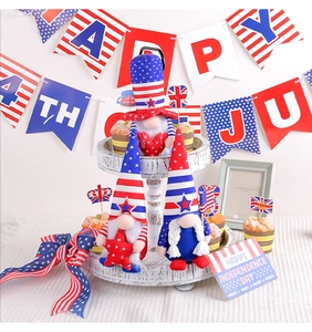 Three Independence Day plush gnomes with stars and stripes on a rustic tiered tray