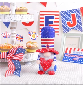 Patriotic gnome decoration with US flag hat holding a red star heart on a festive tray