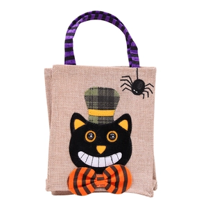 Detail of Halloween gift bag with black cat design, spider embroidery, and striped handles