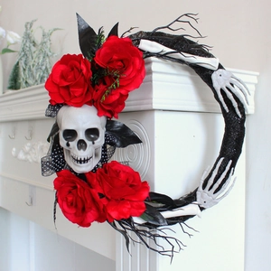 Halloween wreath with skull, red roses, and skeleton hands on a gothic black twig base