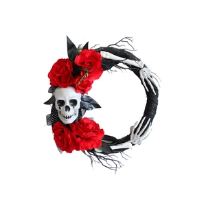 Halloween wreath with red roses, white skull, skeleton hands, and black branches on white base