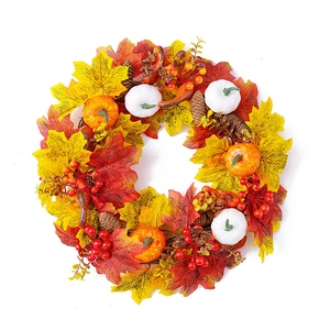Autumn wreath with white pumpkins, maple leaves, and berries for Thanksgiving door decor