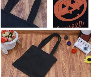 Close-up detail of reinforced stitching on handles and pumpkin print of Halloween tote bag