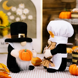 Detail of harvest gnomes with pumpkin and chef hat on an autumn background