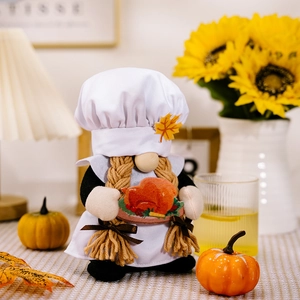 Detail of chef gnome figurine with braids holding turkey for Thanksgiving decor