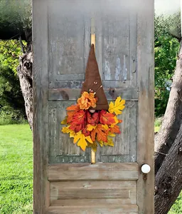 Detail of harvest gnome door decor with felt hat and vibrant autumn maple leaf beard