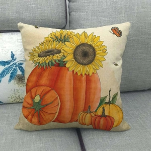 Close-up of linen cushion cover featuring sunflower and pumpkin harvest motifs