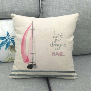Close-up of linen pillow cover featuring a sailboat and Let Your Dreams Set Sail quote