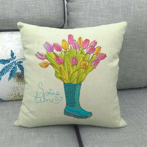Detailed close-up of linen pillowcase with Spring time rain boots and tulip print