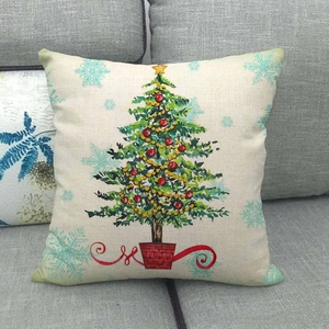 Nordic linen Christmas tree pillow cover with colorful ornaments on a grey sofa