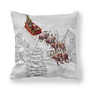 Detail of Christmas pillow cover featuring Santa in a reindeer sleigh over a snowy town
