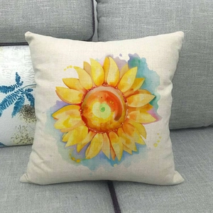 Detail of linen pillow cover featuring watercolor sunflower print on gray sofa
