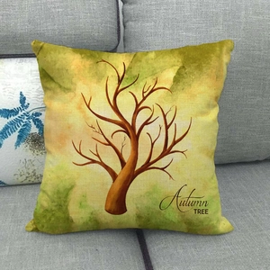 Detailed close-up of autumn tree printed linen cushion cover on a gray sofa