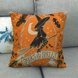 Detail of Halloween throw pillow with Spooks & Spells print on orange linen fabric
